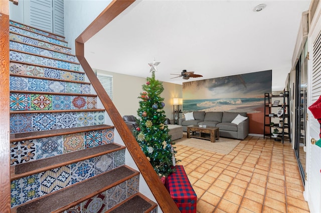 stairway with tile patterned flooring and ceiling fan