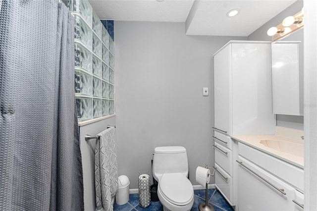 bathroom with a shower with curtain, vanity, toilet, and tile patterned flooring