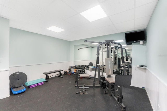 exercise room with a paneled ceiling