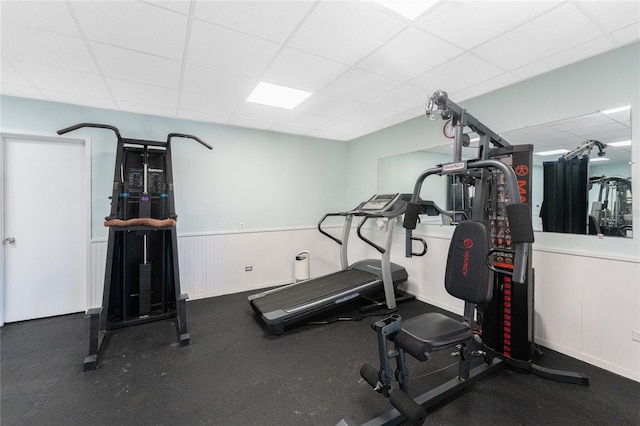 workout room with a paneled ceiling