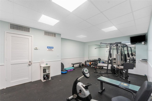 exercise room featuring a drop ceiling