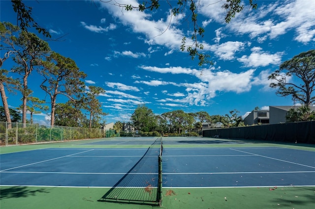 view of tennis court featuring basketball hoop