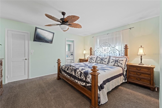 carpeted bedroom with ensuite bathroom and ceiling fan