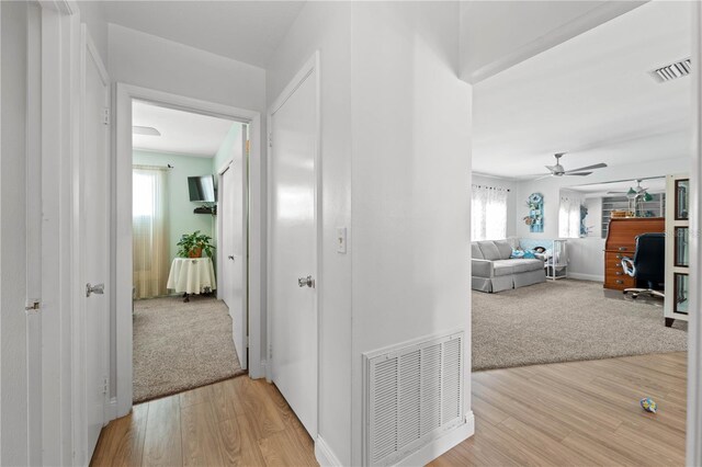 922 Casey Cove Dr, Nokomis, FL 34275 - hallway featuring carpet flooring, wood finished floors, and visible vents