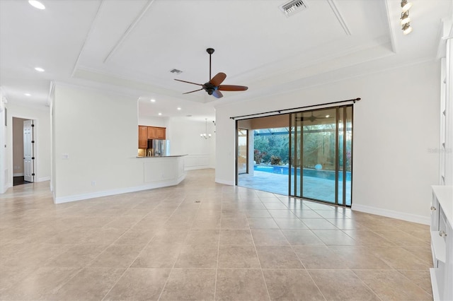 unfurnished living room featuring ceiling fan, ornamental molding, and a tray ceiling