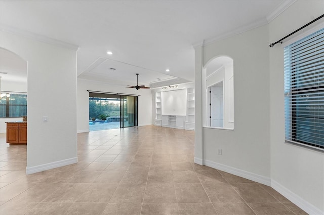 unfurnished living room with built in shelves, light tile patterned floors, ceiling fan, and ornamental molding