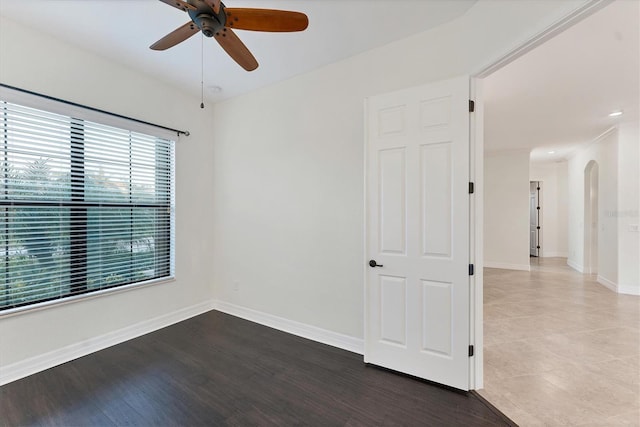 spare room with ceiling fan and wood-type flooring