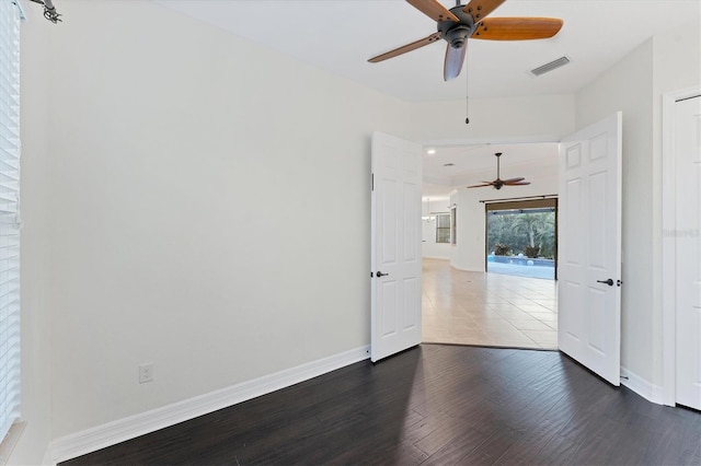 unfurnished room with dark hardwood / wood-style flooring