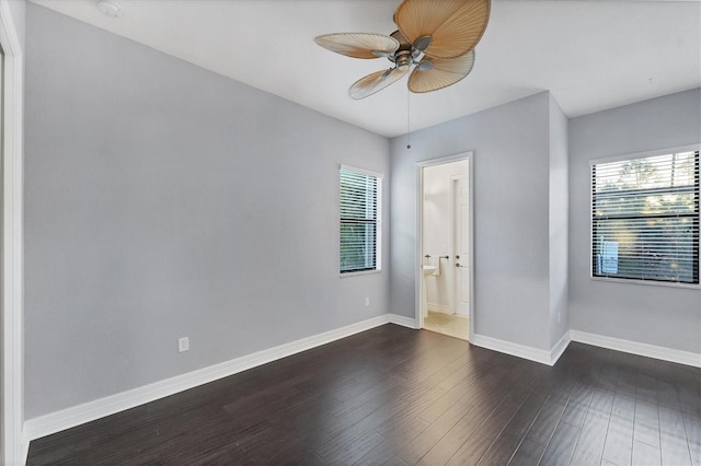 spare room with ceiling fan and dark hardwood / wood-style flooring