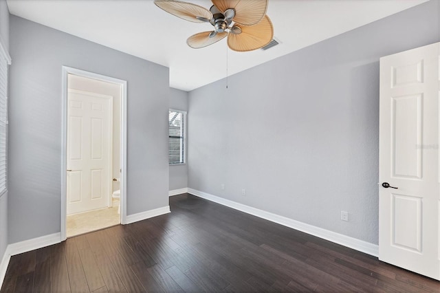 unfurnished bedroom featuring ceiling fan and dark hardwood / wood-style floors