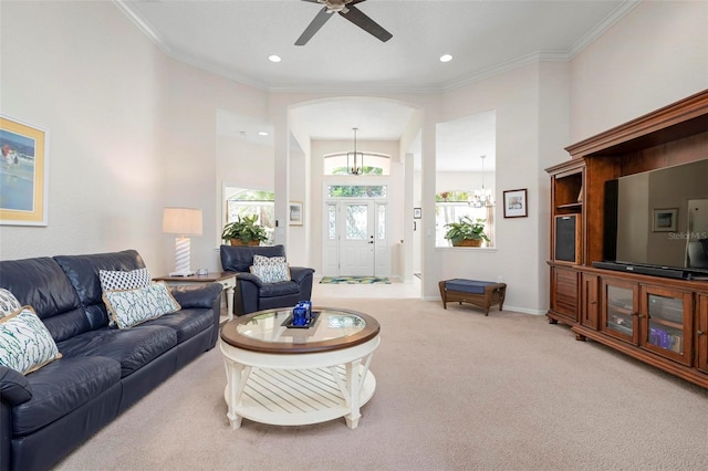 living room with carpet, ceiling fan, and crown molding