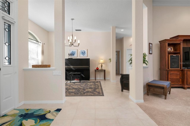 carpeted entryway featuring a notable chandelier