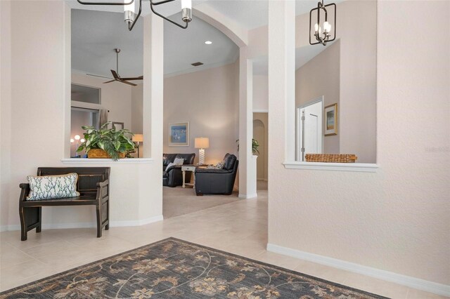 corridor featuring a notable chandelier and light tile patterned floors