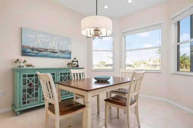 dining area with light tile patterned floors and a chandelier