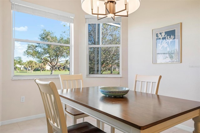 dining space featuring light tile patterned floors and a chandelier