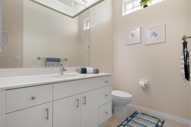 bathroom with tile patterned floors, vanity, and toilet