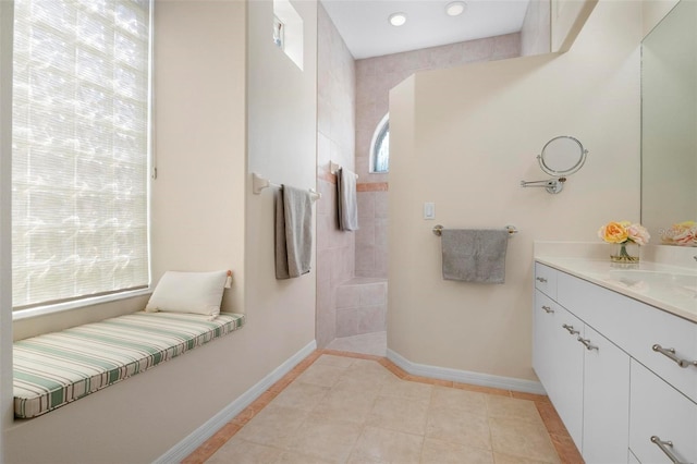 bathroom with tile patterned floors, vanity, and a shower