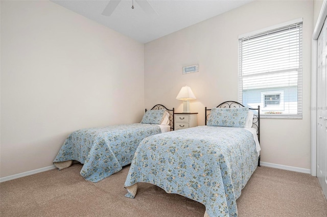 bedroom featuring multiple windows, ceiling fan, and light carpet