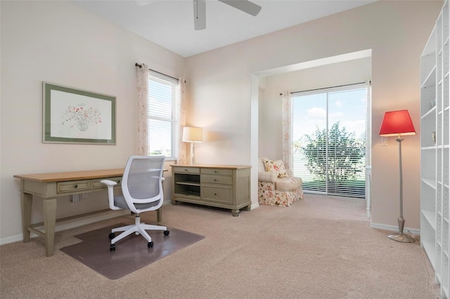 home office with ceiling fan, light carpet, and a wealth of natural light