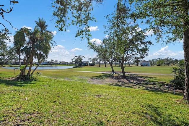 view of home's community with a yard and a water view