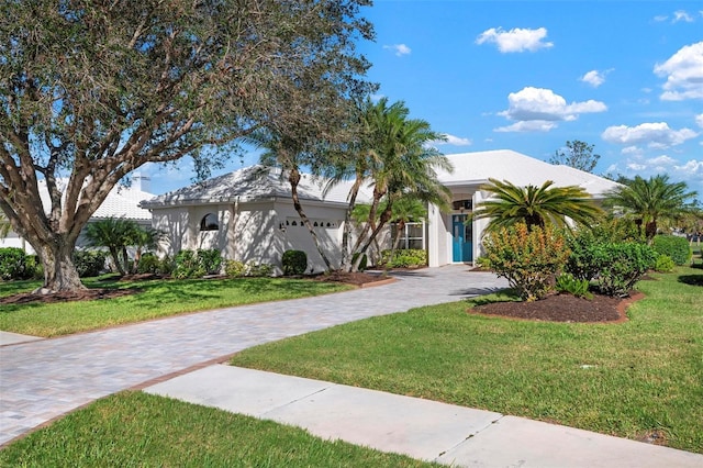 view of front of house with a front yard and a garage