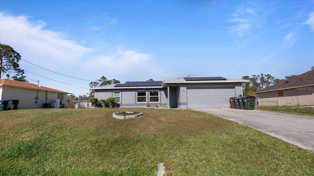 view of front of property with solar panels, a garage, and a front lawn