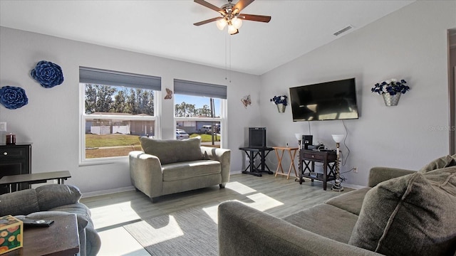 living room with light hardwood / wood-style floors, ceiling fan, and lofted ceiling