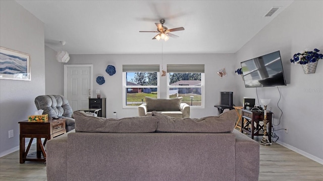 living room featuring ceiling fan and hardwood / wood-style floors