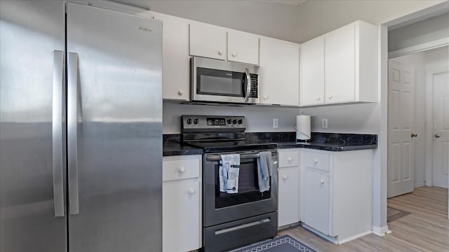 kitchen featuring white cabinetry, light hardwood / wood-style flooring, and appliances with stainless steel finishes