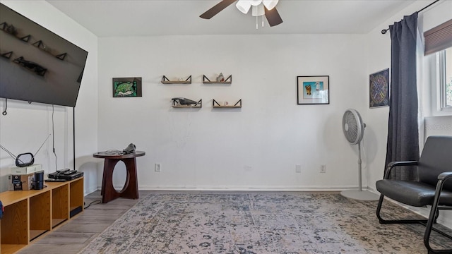 living area with ceiling fan and light wood-type flooring