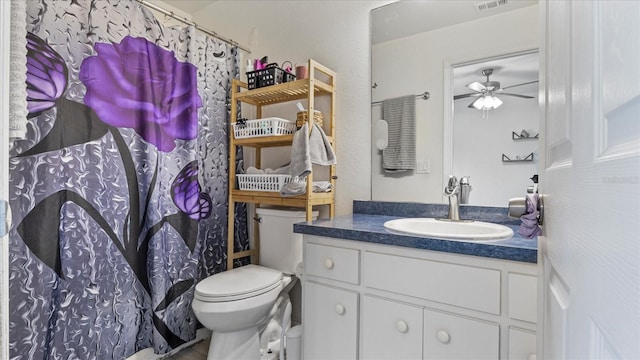 bathroom featuring vanity, toilet, and ceiling fan