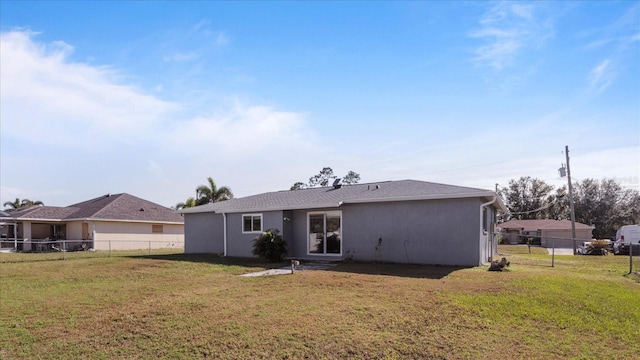 rear view of house with a yard