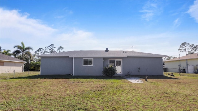 rear view of house featuring a yard