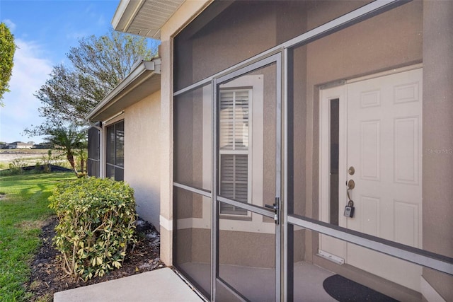 property entrance with a yard