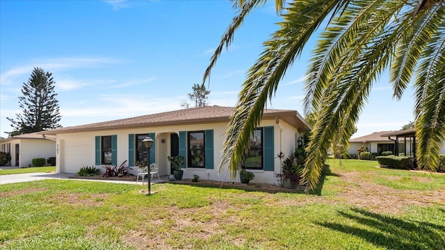 ranch-style home featuring a garage and a front yard