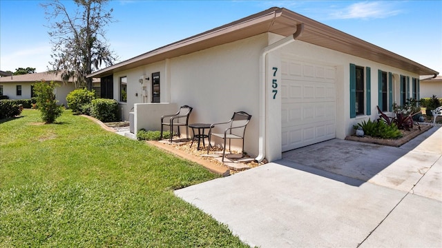 view of side of home featuring a yard and a garage