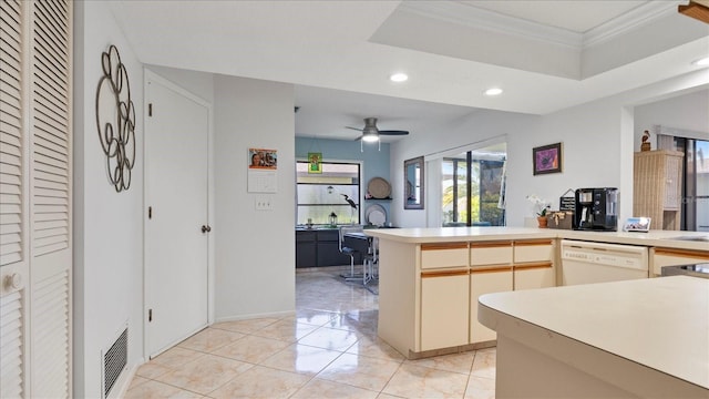 kitchen featuring dishwasher, a raised ceiling, ceiling fan, ornamental molding, and kitchen peninsula