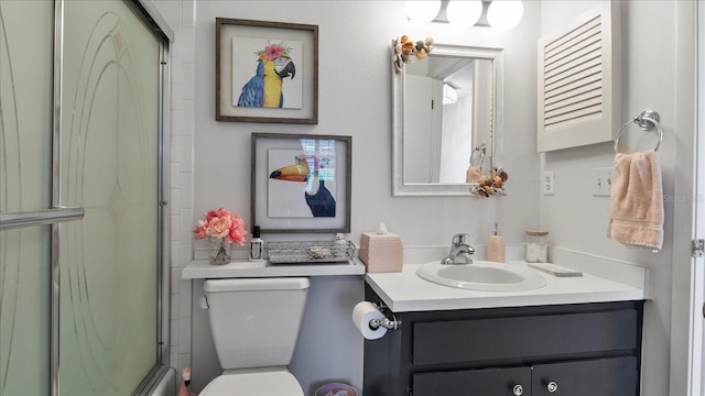 bathroom featuring walk in shower, vanity, and toilet