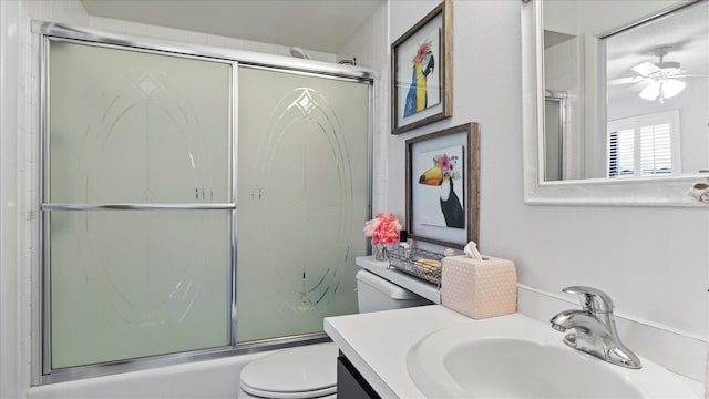 full bathroom with vanity, ceiling fan, toilet, and enclosed tub / shower combo