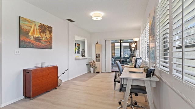 office area with light hardwood / wood-style floors