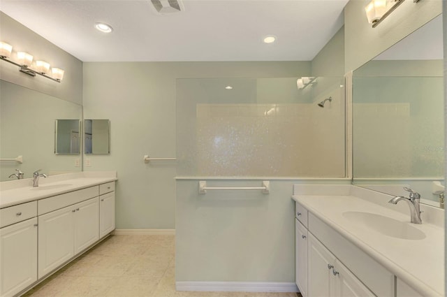 bathroom featuring tile patterned floors, a shower, and vanity