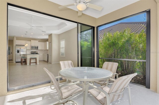 sunroom featuring ceiling fan