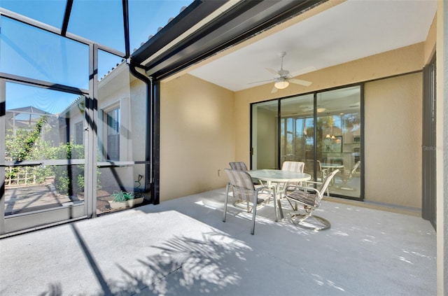 view of patio featuring a lanai and ceiling fan