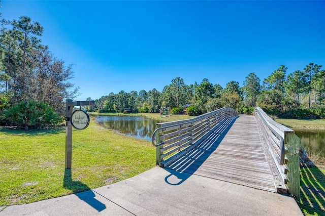 surrounding community featuring a yard and a water view