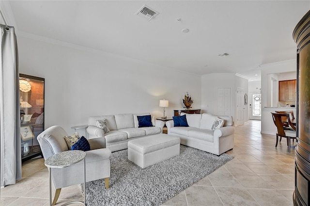 living room with ornamental molding and light tile patterned flooring