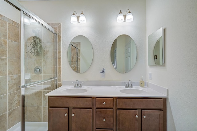 bathroom with vanity and a shower with door