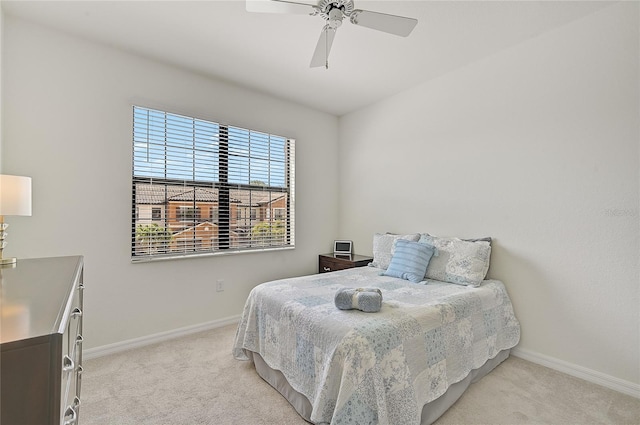 bedroom featuring ceiling fan and light carpet