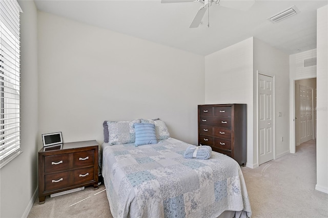 carpeted bedroom featuring ceiling fan and a closet