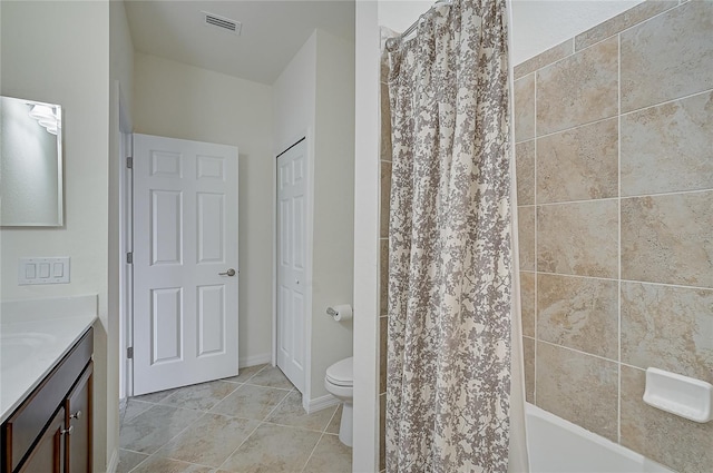 bathroom featuring tile patterned floors, vanity, and toilet