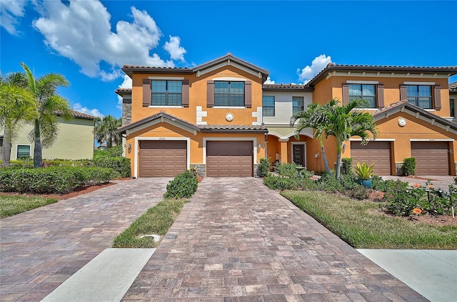 mediterranean / spanish home featuring a garage